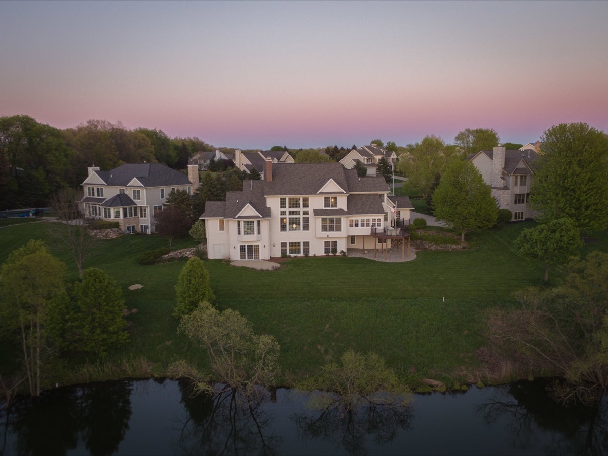Aerial twilight drone shot of a luxury home at pink dusk