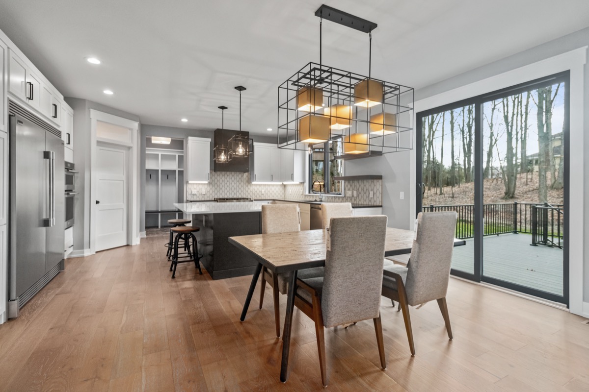 Modern open-plan dining and kitchen with statement pendant lighting